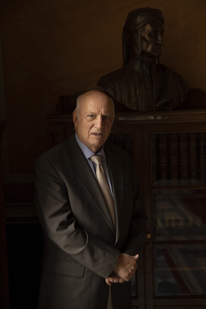 Portrait of Dr. Zerefos beside a bronze bust in his library, photographed by Mathias Kessler