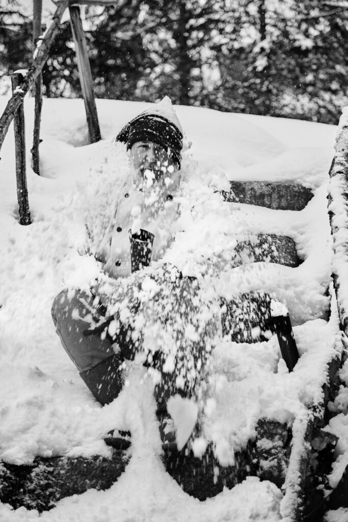 Jeremias Riezler in a burst of snow, black-and-white portrait by Mathias Kessler